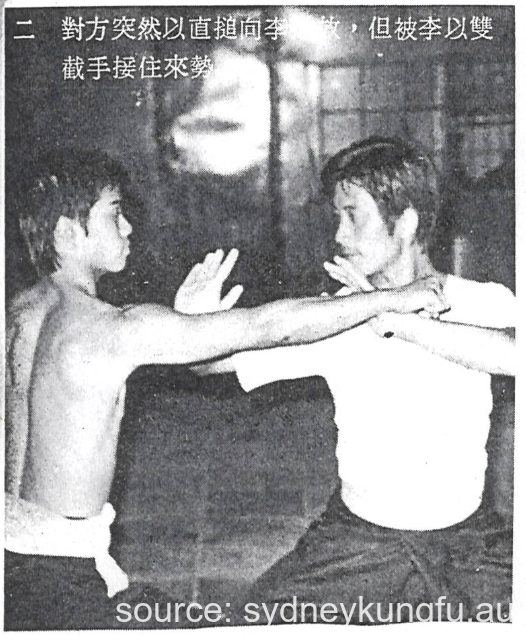2. The opponent suddenly attacks Lee with a straight punch, but Lee intercepts the attack with Seung Jit Sau (soeng jit sau 雙截手)