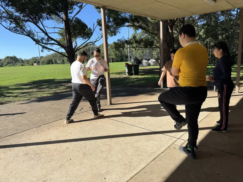 Adult students practicing partner drills outdoors at Hornsby Kung Fu class