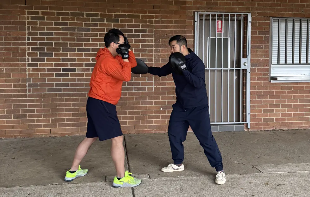 Adult students doing pad work self-defense training at Hornsby Kung Fu class